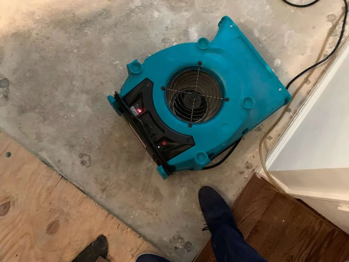 Air mover drying subfloor during Commercial Water Damage Restoration in Sumter